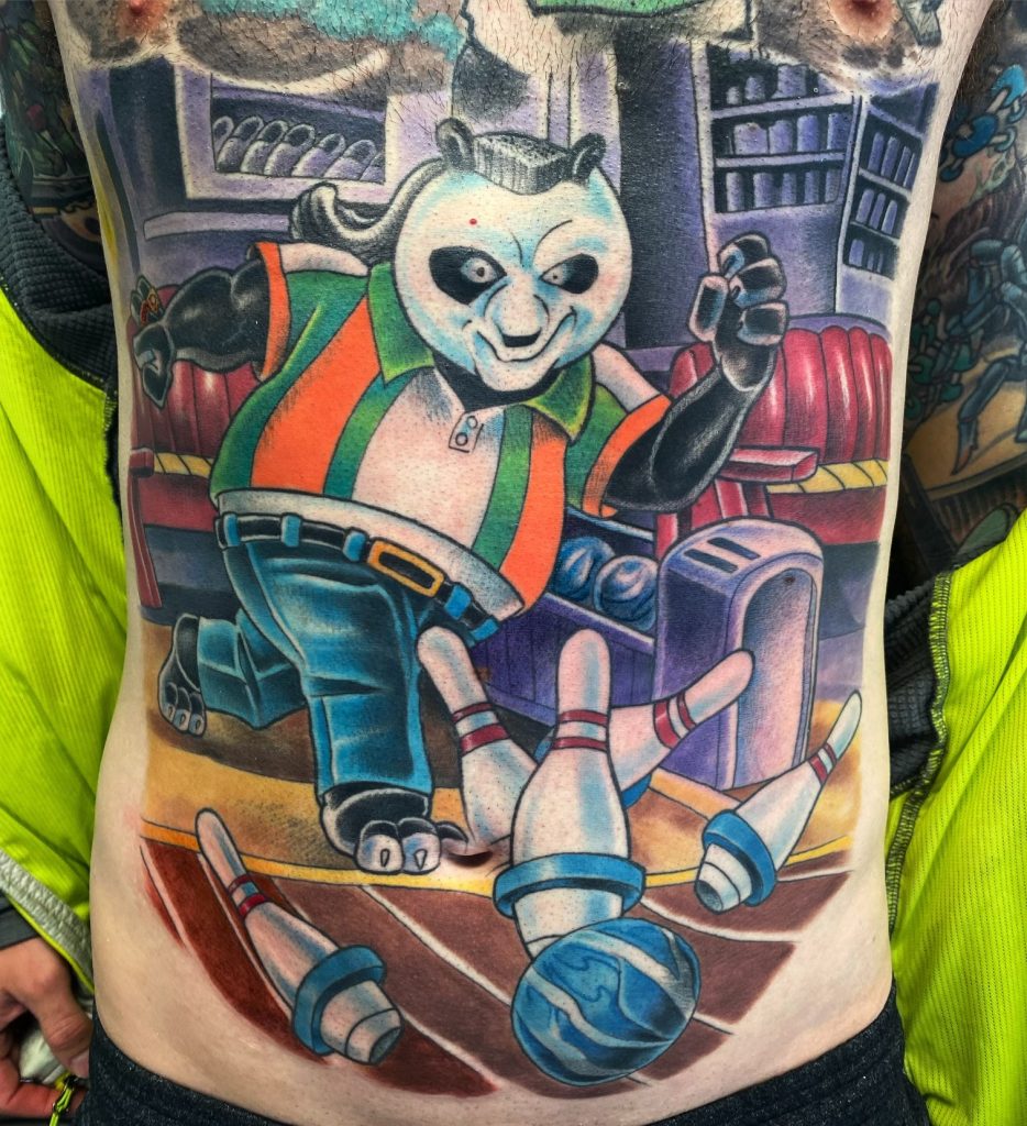 Full-colour bowling panda tattooed across the stomach by Brett Schwindt