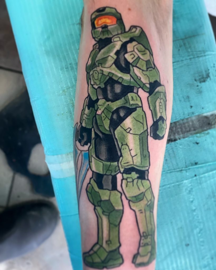 Full-colour Halo Master Chief tattooed on a forearm by Brett Schwindt