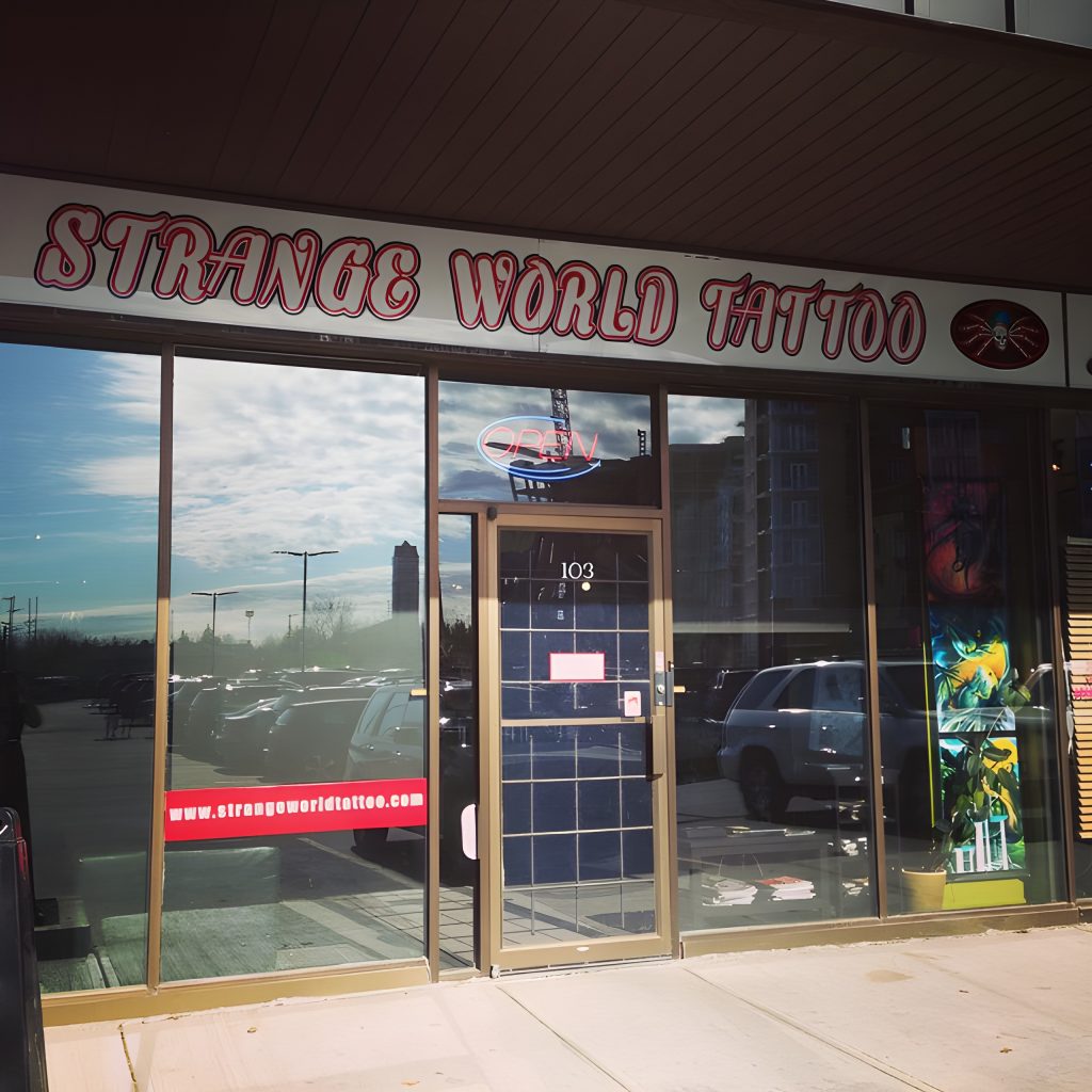 The Strange World Tattoo shopfront and hand-painted sign on Crowchild Trail N.W.