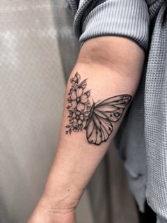 Fine line butterfly and florals on an upper arm by Valeriia Mosina