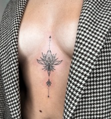 Fine line ornamental sternum tattoo by Valeriia Mosina