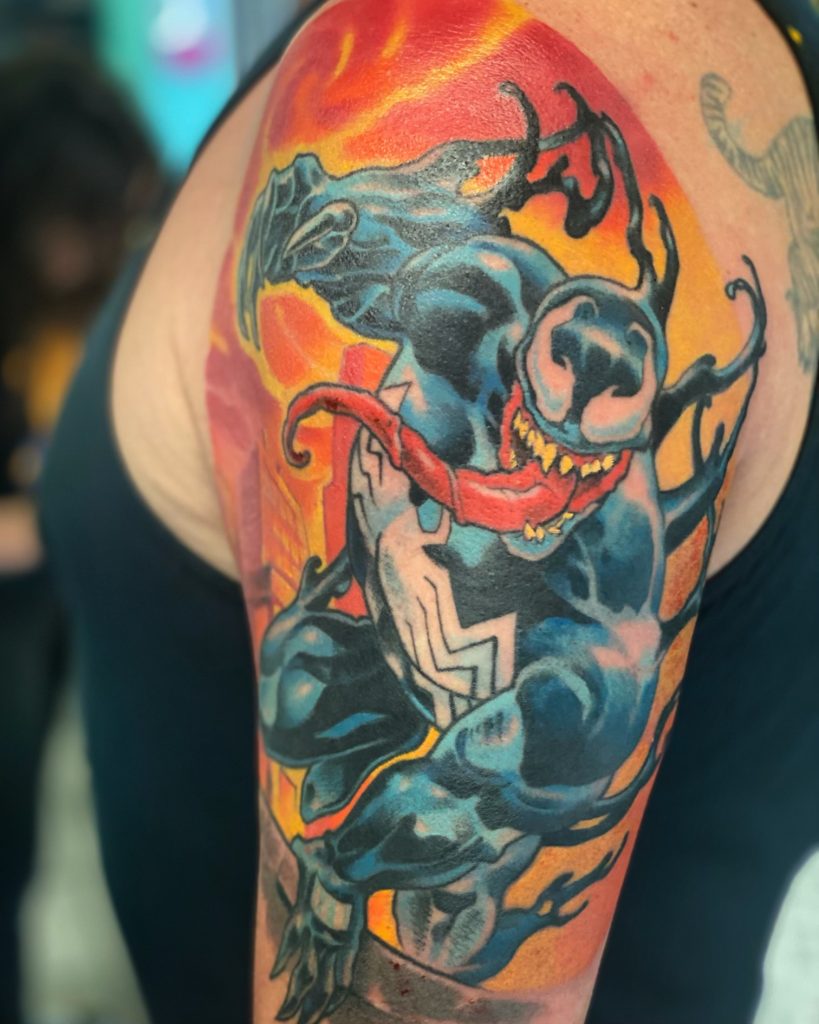 Full-colour Marvel Venom tattooed on an upper arm by Brett Schwindt