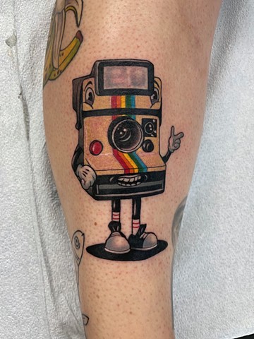 Rubber-hose style Polaroid camera tattoo by Kristin Fraser