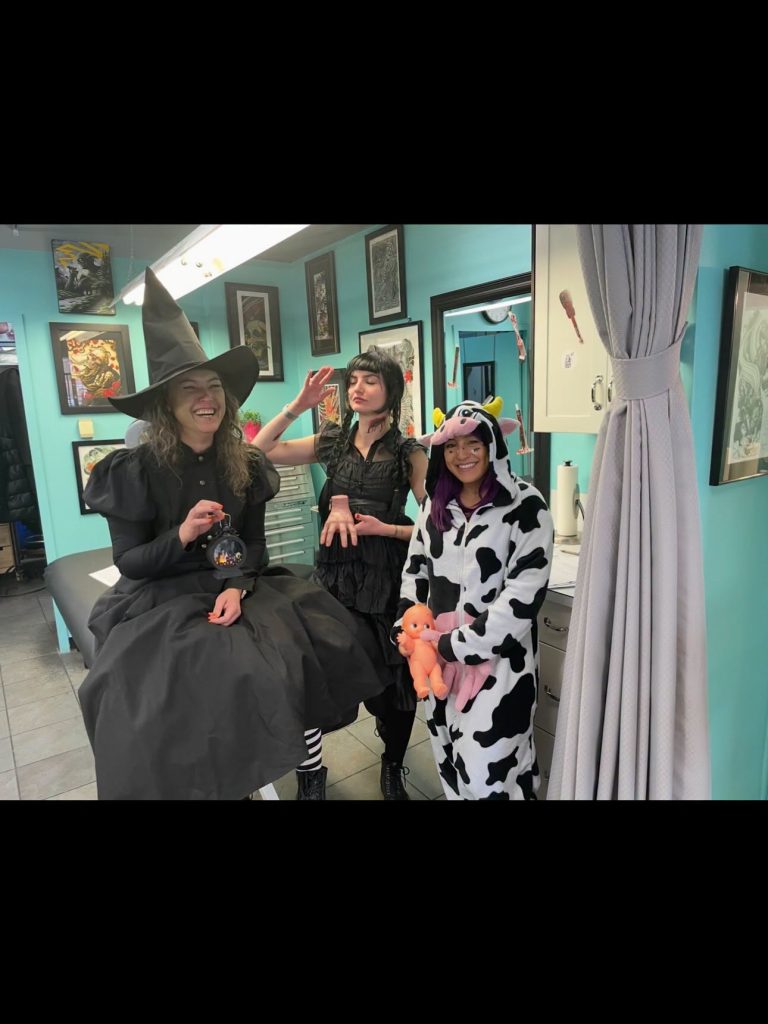 Strange World staff in Halloween costumes in the studio