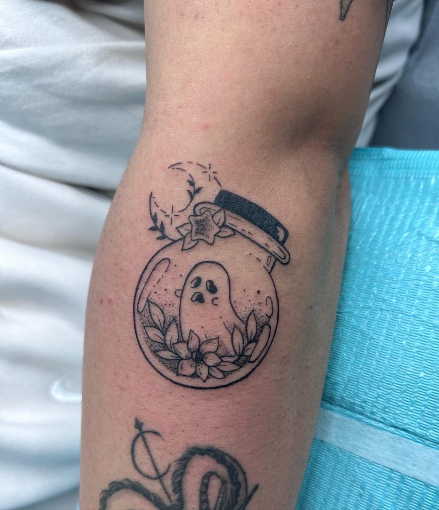 Fine line ghost inside a jar of flowers, tattooed on a forearm by Abi Rojas